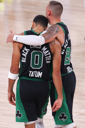 Jayson Tatum and Daniel Theis celebrate after Boston's win over Miami.