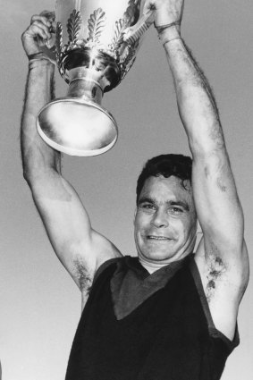 Ron Barassi holds the 1964 premiership cup aloft.
