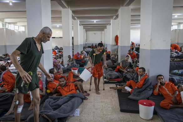 Suspected Islamic State members, many of them badly injured from the final months of battle, languish inside a large crowded cell at a prison controlled by Kurdish forces in north-east Syria in 2019.