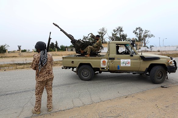 Government forces on patrol outside Tripoli.