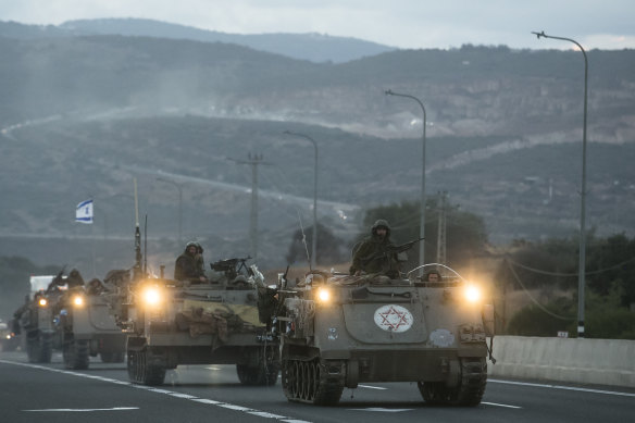 Israeli armoured personnel carriers move in formation near the border with Lebanon.