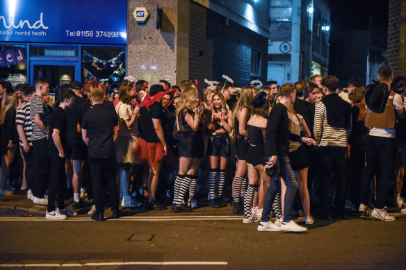 People wait to pass through security measures to enter a popular bar in Nottingham, England on Oct. 20, 2021, where there have been alarming reports of women being injected with syringes at crowded pubs and nightclubs.