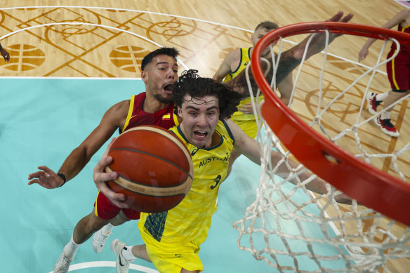 Josh Giddey, of Australia, shoots in front of Willy Hernangomez, of Spain.