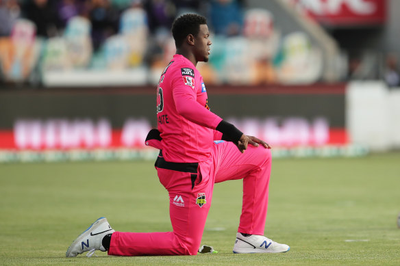 Carlos Brathwaite takes a knee at Blundstone Arena during the Big Bash.