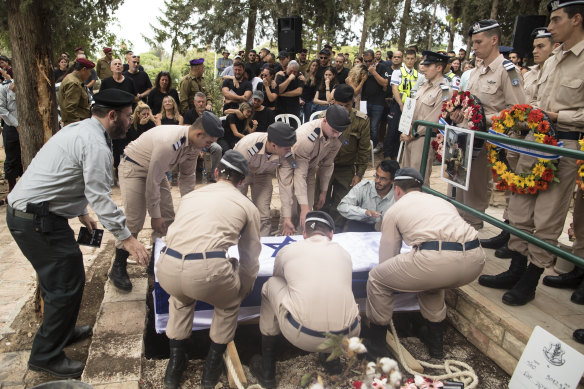 Family and friends gather at the funeral of an Israel Defence Forces soldier killed by Hamas.
