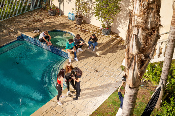 Members hang by the pool of the Hype House in Los Angeles .