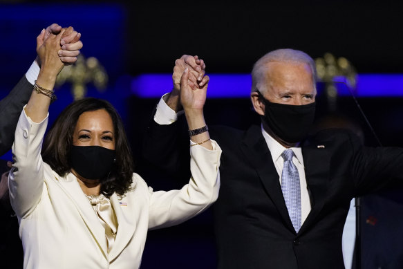 Masked victors Kamala Harris and Joe Biden celebrate their election-clinching vote tally on November 7.