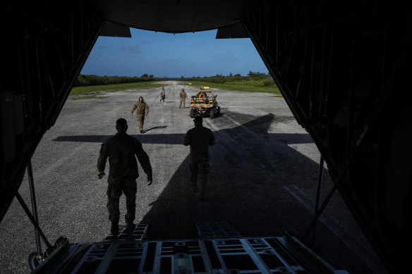 American airmen unload equipment on one of World War II-era runways on the Pacific isle of Tinian, Northern Mariana Islands, on February 17, 2023.
