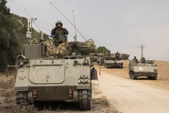 Israeli armoured personnel carriers drive towards Israel’s southern border with the Gaza Strip.