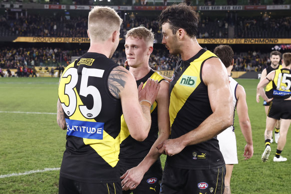 Teammmates console Richmond’s Noah Cumberland after he played on denying himself a chance to win the match.