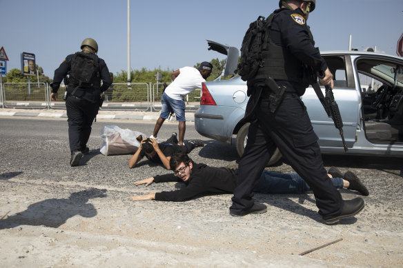 Police officers check suspects at a checkpoint in Ashdod, Israel, searching for Hamas militants from Gaza Strip.