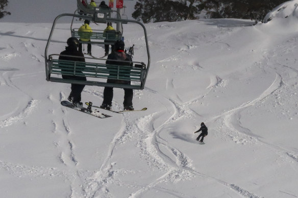 A snowboarder slices through fresh snow at Perisher after heavy falls over the weekend. 