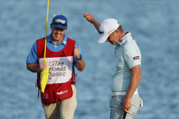 Matt Jones celebrates with caddie Lance Bailey on the 18th green after his victory at the Honda Classic.