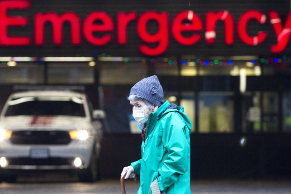 An elderly woman walks past the Emergency Department of the Vancouver General Hospital in British Columbia.