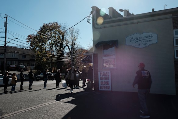 Customers line up outside Holtermann’s Bakery on Staten Island in New York on Saturday.