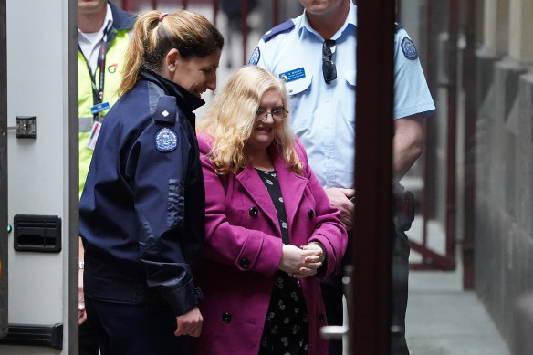 Christine Lyons being led into the Supreme Court in 2018.
