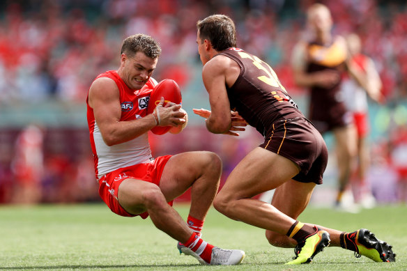 Sydney forward Tom Papley keeps the ball off Hawthorn’s Finn Maginness on Sunday.