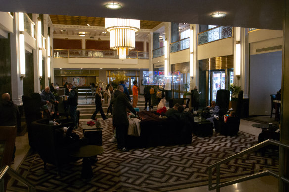 Guests in the lobby of the New Yorker Hotel which also serves as the headquarters for a religious sect.