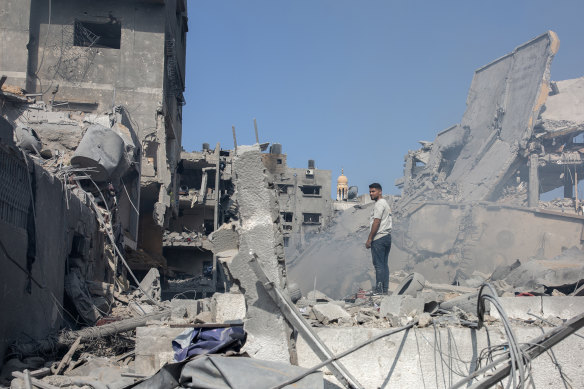 A man views the destruction following Israeli airstrikes on the Al-Rimal neighbourhood of Gaza City.