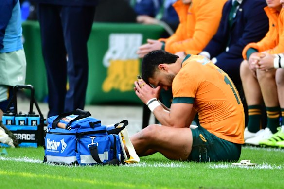 Tom Wright sitting on the sideline after coming off injured.
