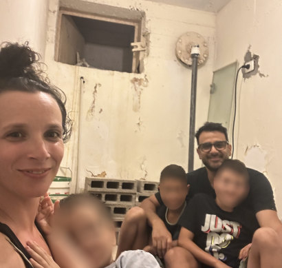 Emily and Tomer Gian, and their three children, inside their bomb shelter.