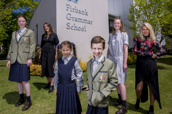 Students in an early version of the uniform with designer Kit Willow, right, and principal Jenny Williams, second from left.