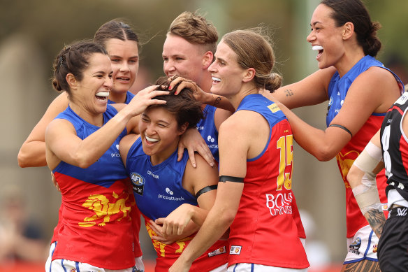 Luka Yoshida-Martin is congratulated by Lions teammates after scoring.