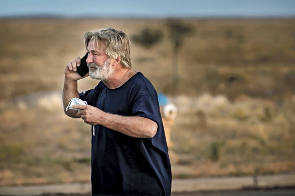 Alec Baldwin speaks on the phone in the parking lot outside the Santa Fe County Sheriff’s Office in Santa Fe after he was questioned about the shooting.