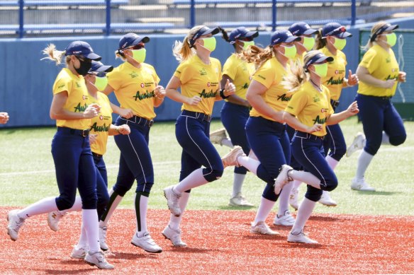 Australia’s softball team warm up before training at Yokohama Baseball Stadium.