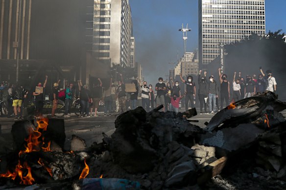 Demonstrators clash with riot police during a protest against Brazilian President Jair Bolsonaro amid the coronavirus pandemic at Paulista Avenue in Sao Paulo.