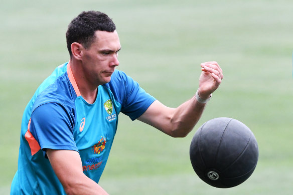 Scott Boland warms up during training in Adelaide.