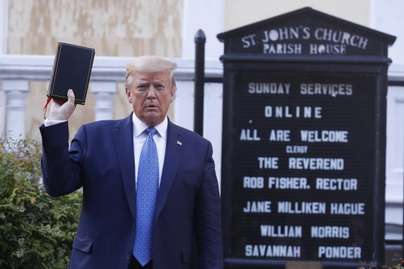 US President Donald Trump poses with a Bible outside St John's Episcopal Church near the White House in June. A new super PAC says Trump has "in a predatory way attached himself to Christians".