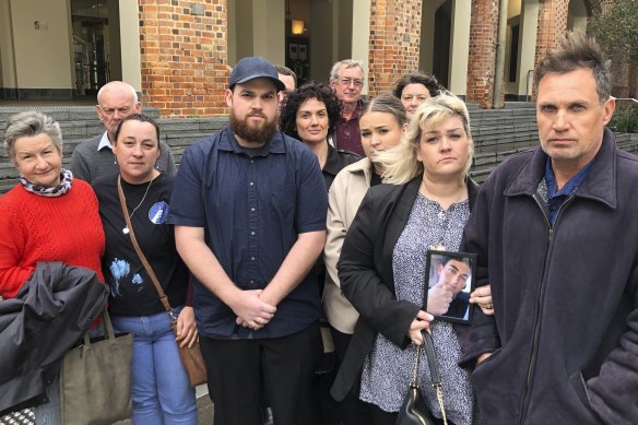 Pamella and Chris Fink, far right, were surrounded by family and supporters during the Supreme Court hearing where they sought to get an inquest into their son’s suicide.