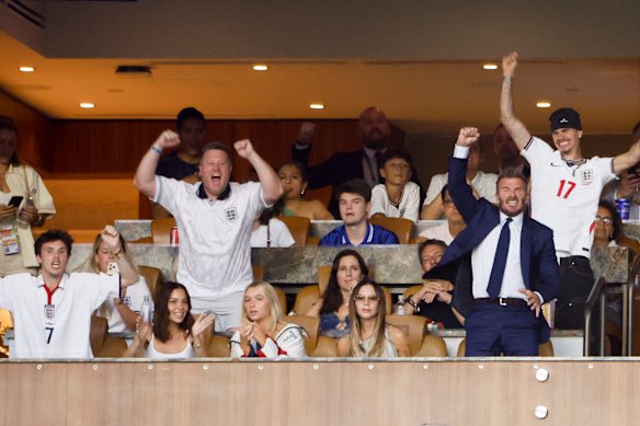 Victoria Beckham’s notorious dislike of smiling in public made for a hilarious moment at the England vs Norway quarter-final game in Florida. From left: Cruz Beckham, girlfriend Jackie Apostel, Harper Beckham, Victoria, David and Romeo Beckham.