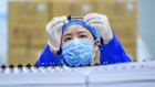 A worker inspects bioactive peptides at a workshop of Hubei Reborn Biotech in Hubei Province.