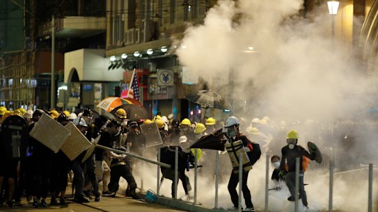 Police fire tear gas at protesters in Hong Kong on Sunday night.