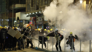 Police fire tear gas at protesters in Hong Kong on Sunday night.