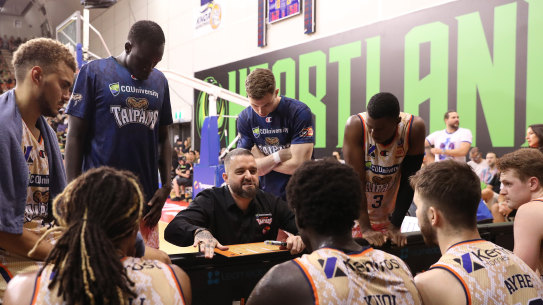 Taipans players are addressed by their coach during a game on Wednesday.