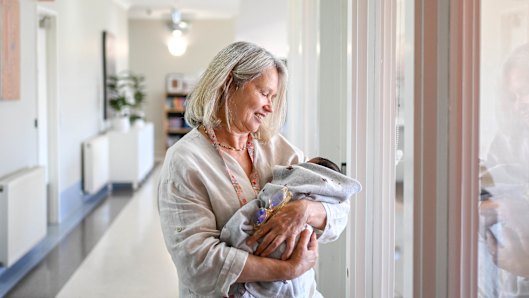 A nurse in Safe Steps’ pilot ‘wrap around’ crisis centre cradles a newborn.