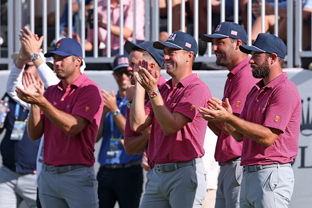 Sam Burns, Justin Thomas and Scottie Scheffler celebrate victory.