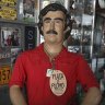 Tourists buy souvenirs of the late drug lord Pablo Escobar, featured as a statue with a sign that says one will be charged for taking photos inside a store in Doradal, Colombia.