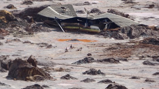 A structure is buried in mud in the Bento Rodrigues valley after BHP-Vale's Samarco dam failure in 2015.