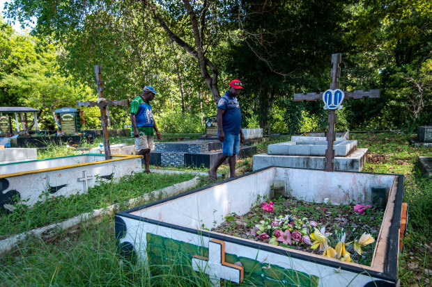 Kabai and Pabai at the Saibai cemetery, which has had graves and remains washed away in king tides.