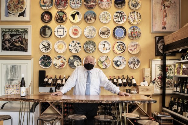 Lucio beside the wall of plates that were first commissioned for the 15th anniversary.