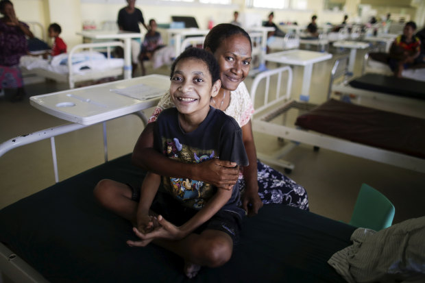 Sylvester Begama, 13, with his mother Theresa Nata.