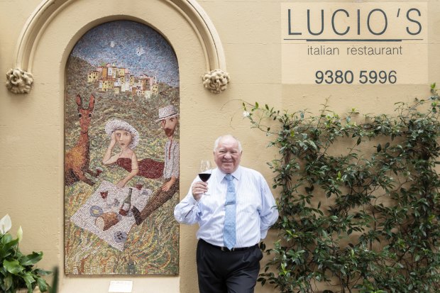 Lucio Galletto enjoying a glass of red beside regular Garry Shead's mosaic.