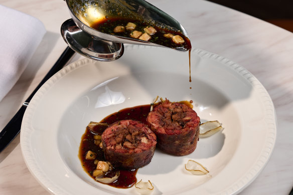 The oxtail is grilled and served with a sauce of bourbon, house-made garum (fermented sauce), and maple syrup.