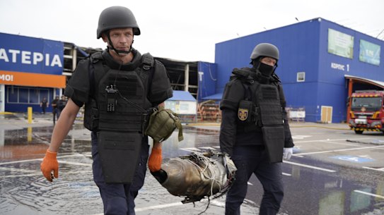 Ukraininan police officers carrying the wreckage of a Russian drone in Kharkiv last month. The strike that killed a 40-year-old man and injured five others was carried out by a Russian Geran-4 jet-powered drone equipped with a camera.