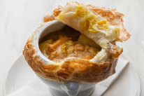 Peel back the lid of the chicken curry pot pie to uncover big chunks of chook and vegetables.