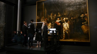 Technicians and researchers check equipment set up inside a glass chamber as they begin to study Rembrandt's 'Night Watch' masterpiece, at the Rijksmuseum in Amsterdam on Monday.